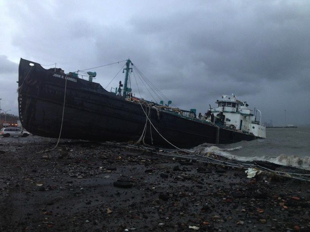 In Staten Island, a record 13 foot storm surge caused the tanker, John B. Caddell, to break free of its morning and run aground in Staten Island. Via Twitter