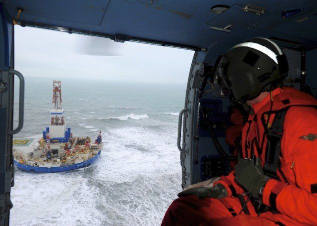 Rear Adm. Thomas Ostebo, commander, 17th Coast Guard District and D17 Incident Management Team commander, observes the conical drilling unit Kulluk from an MH-60 Jayhawk helicopter during a second overflight Tuesday, Jan. 1, 2013. The Kulluk grounded on the southeast shore of Sitkalidak Island Monday night. U.S. Coast Guard photo by Petty Officer 1st Class Sara Francis.
