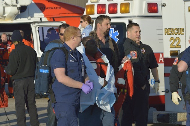 emrgency medical services personnel treat a crewmember from the research vessel Seaprobe at Coast Guard Aviation Training Center Mobile following an airlift approximately 141 miles off the coast of Pensacola, Fla., Jan. 18, 2013. U.S. Coast Guard photo