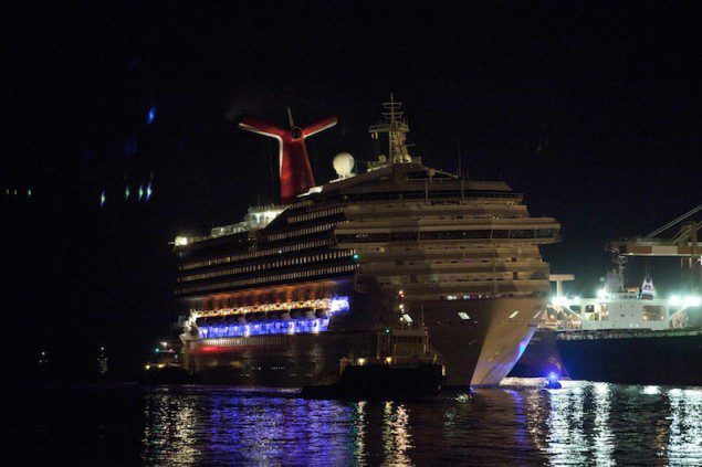 The Carnival Triumph cruise ship is towed towards the dock at the port of Mobile, Alabama, February 14, 2013. REUTERS/ Lyle Ratliff