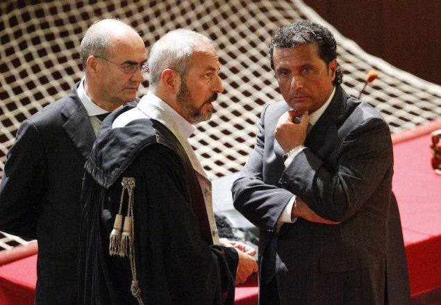 Francesco Schettino (R), captain of the Costa Concordia cruise ship, talks with his lawyers during a trial in Grosseto, central Italy, July 17, 2013. REUTERS/Giampiero Sposito